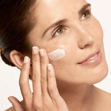 Load image into Gallery viewer, Model applying Microbiome Defense Daytime Moisturizer SPF 15.
